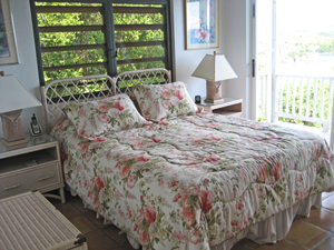St John rental home Altamira bedroom wtih floral decor and sliding glass door onto balcony with views