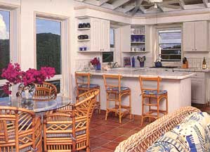 St John USVI vacation rental Viewtiful airy kitchen and dining area with high ceilings opens to the tropically decorated living room